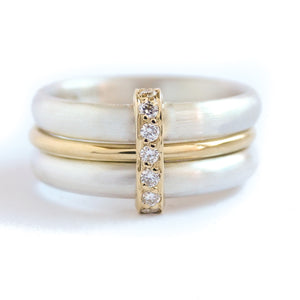 Contemporary treble band looped 18ct gold and diamond ring. Multi banded.