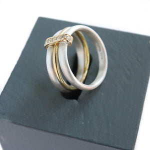 Contemporary treble band looped 18ct gold and diamond ring. Multi banded.